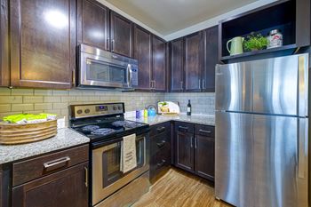 Shaker cabinets and wood-style flooring at 4700 colonnade apartments in birmingham, al